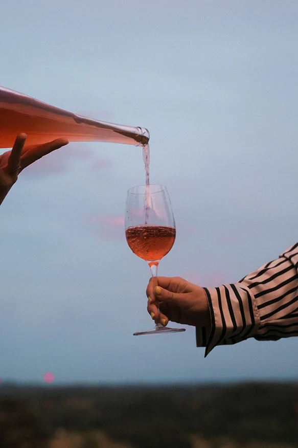 Glass of rosé wine overlooking a Hill Country landscape